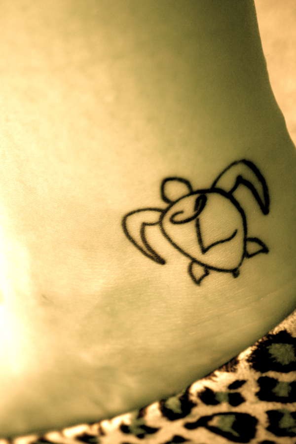 Very small turtle tattoo in minimalist style