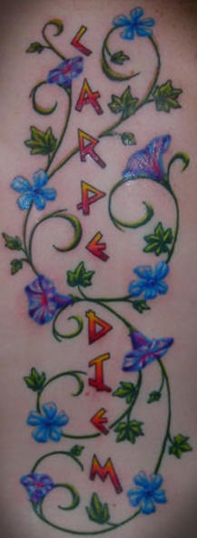 Trumpet vine tattoo with blue flowers and inscription - Tattooimages.biz